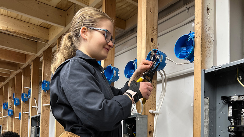 Photo of a female student checking wiring